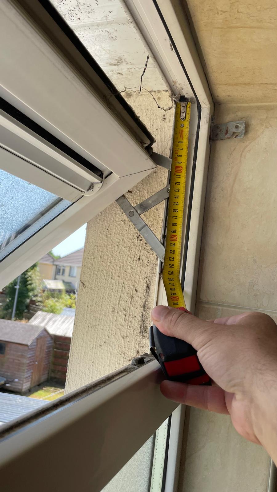 Casement window with visible hinge and frame in a residential home