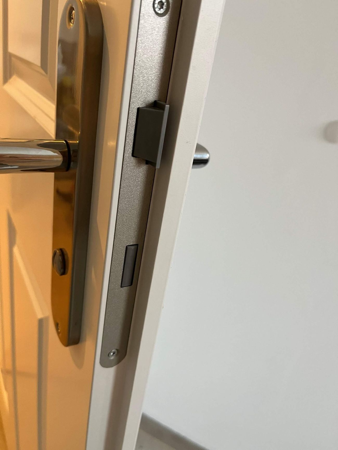 Locksmith checking door alignment and lock operation